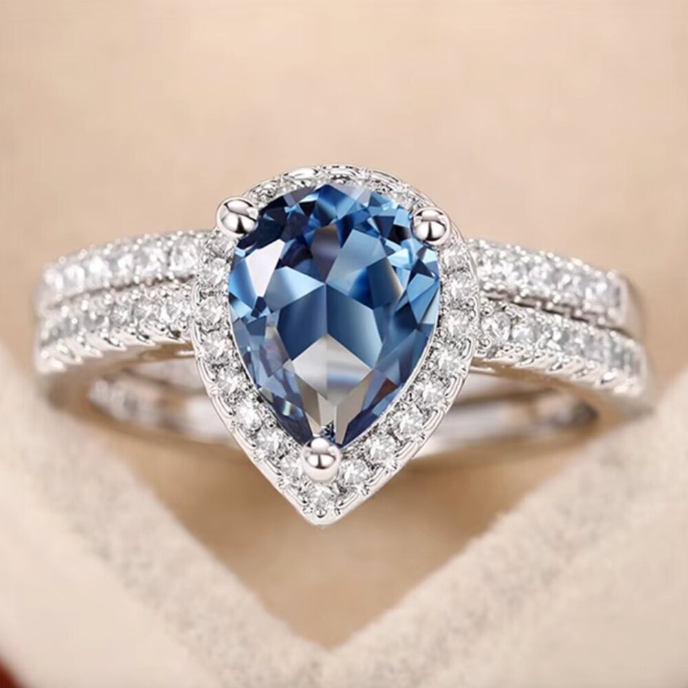 Silver Pear-Cut Blue Halo Ring with Pavé Band